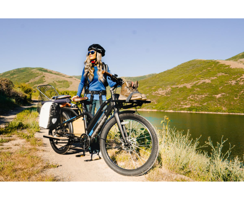 woman walking her magnum payload cargo electric bike by a lake