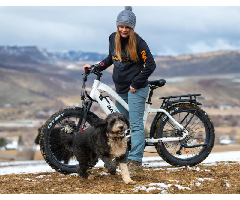 a woman with her dog using the bakcou mule step through electric bike